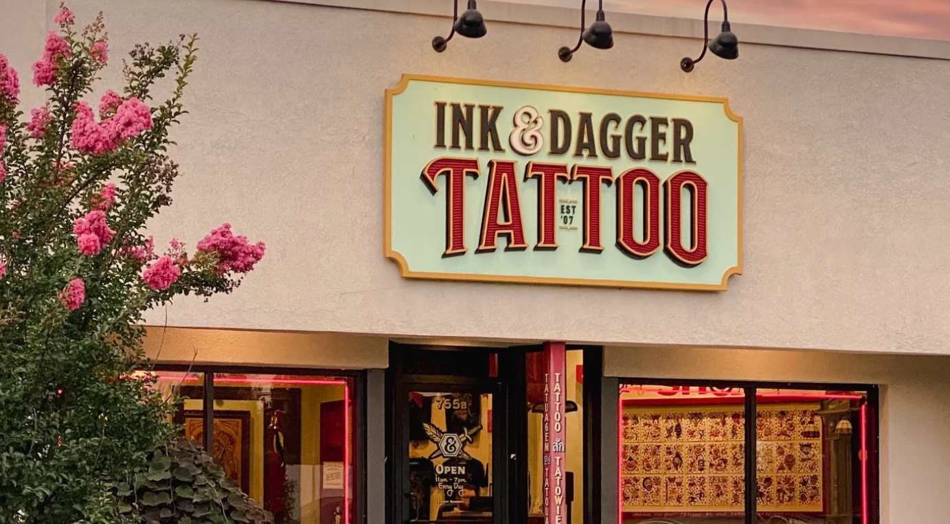 Storefront with the Ink & Dagger Tattoo sign